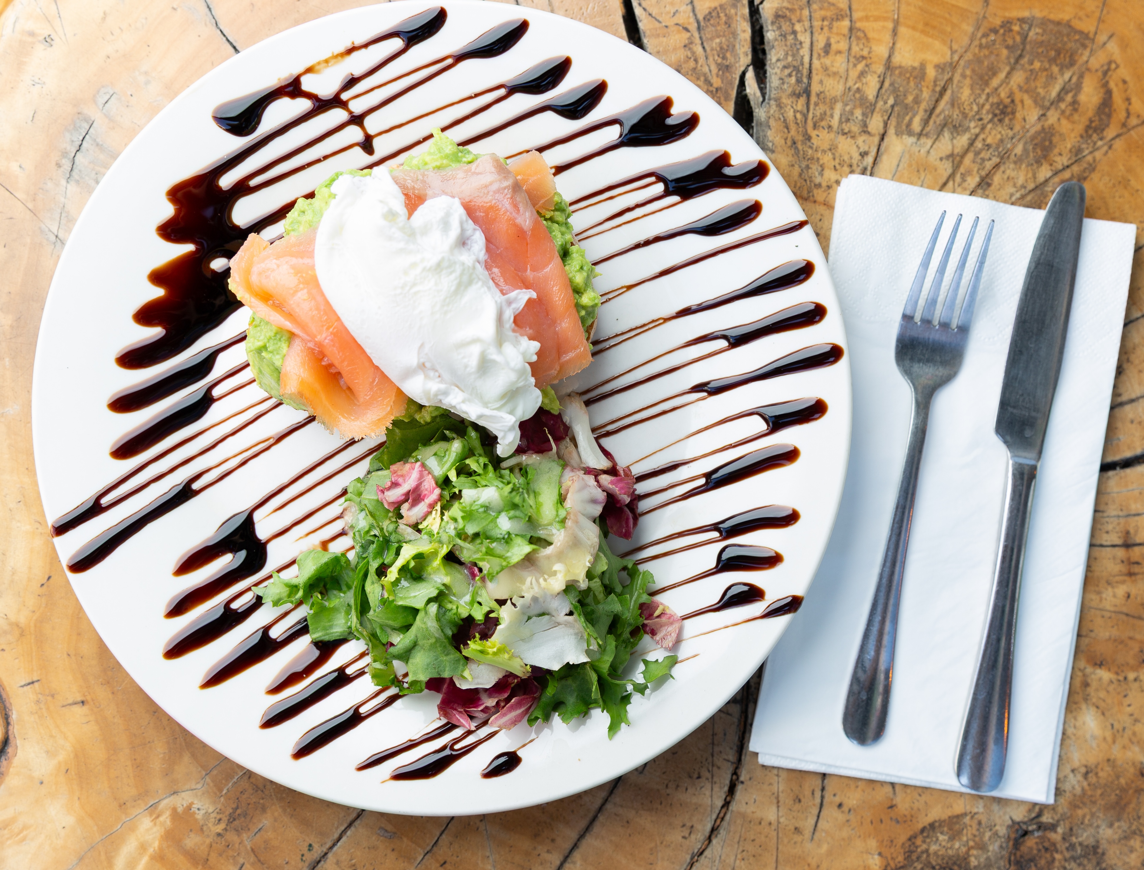 Beautifully plated salmon dish with mixed greens at Octagreen